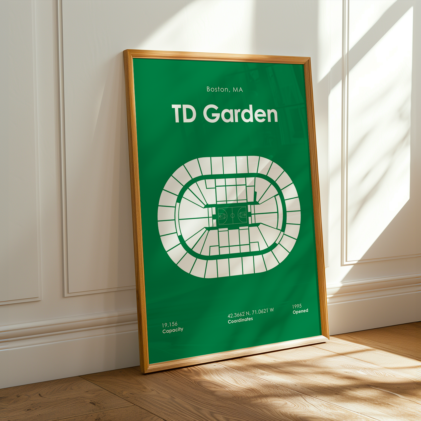 Framed poster of TD Garden layout on a green background in a room with sunlight.