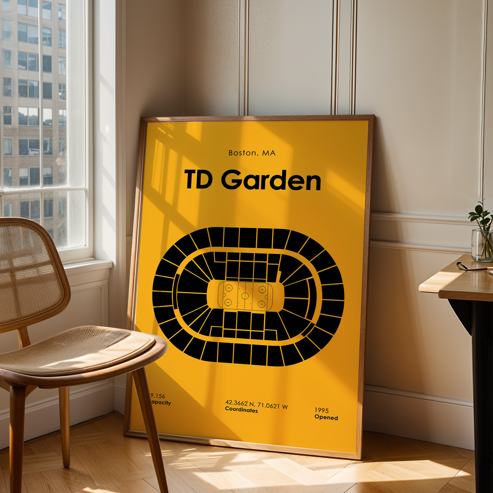 Framed TD Garden map poster on a wall next to a chair and window.