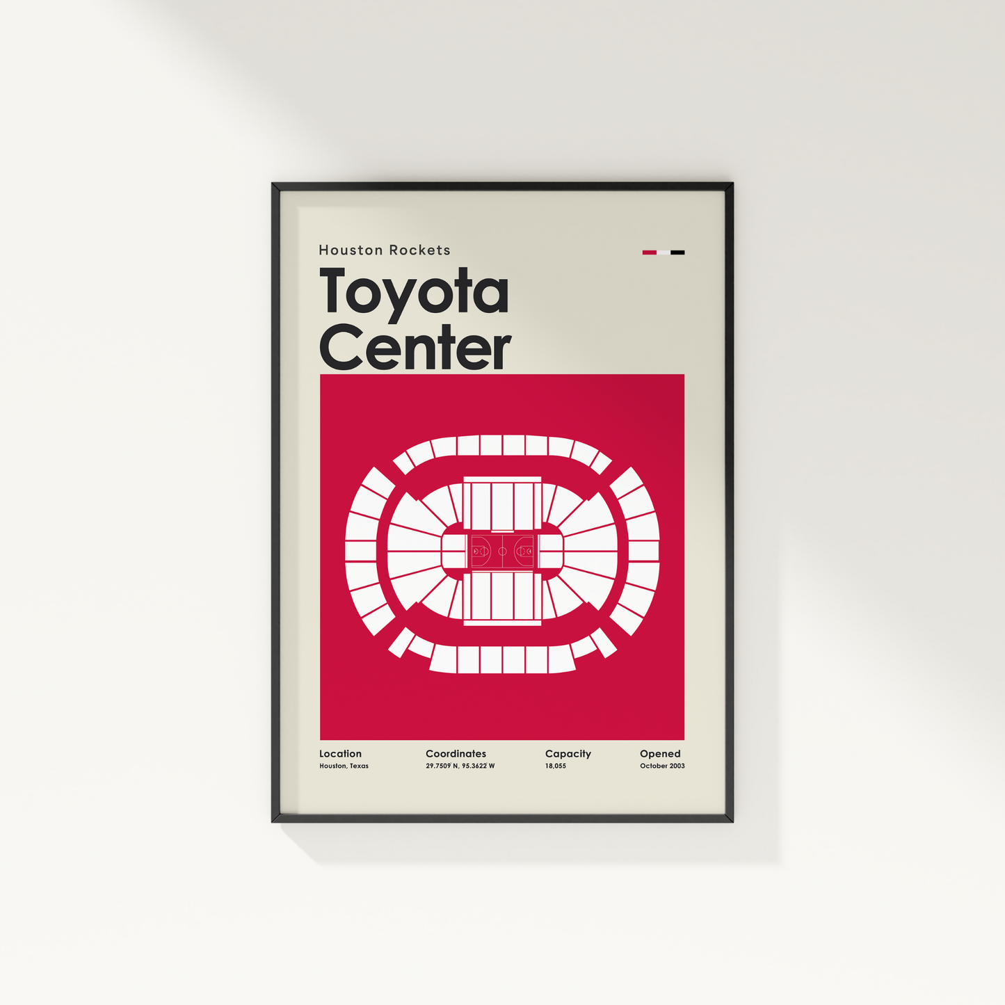 Framed poster of Toyota Center with Houston Rockets branding on a white wall.