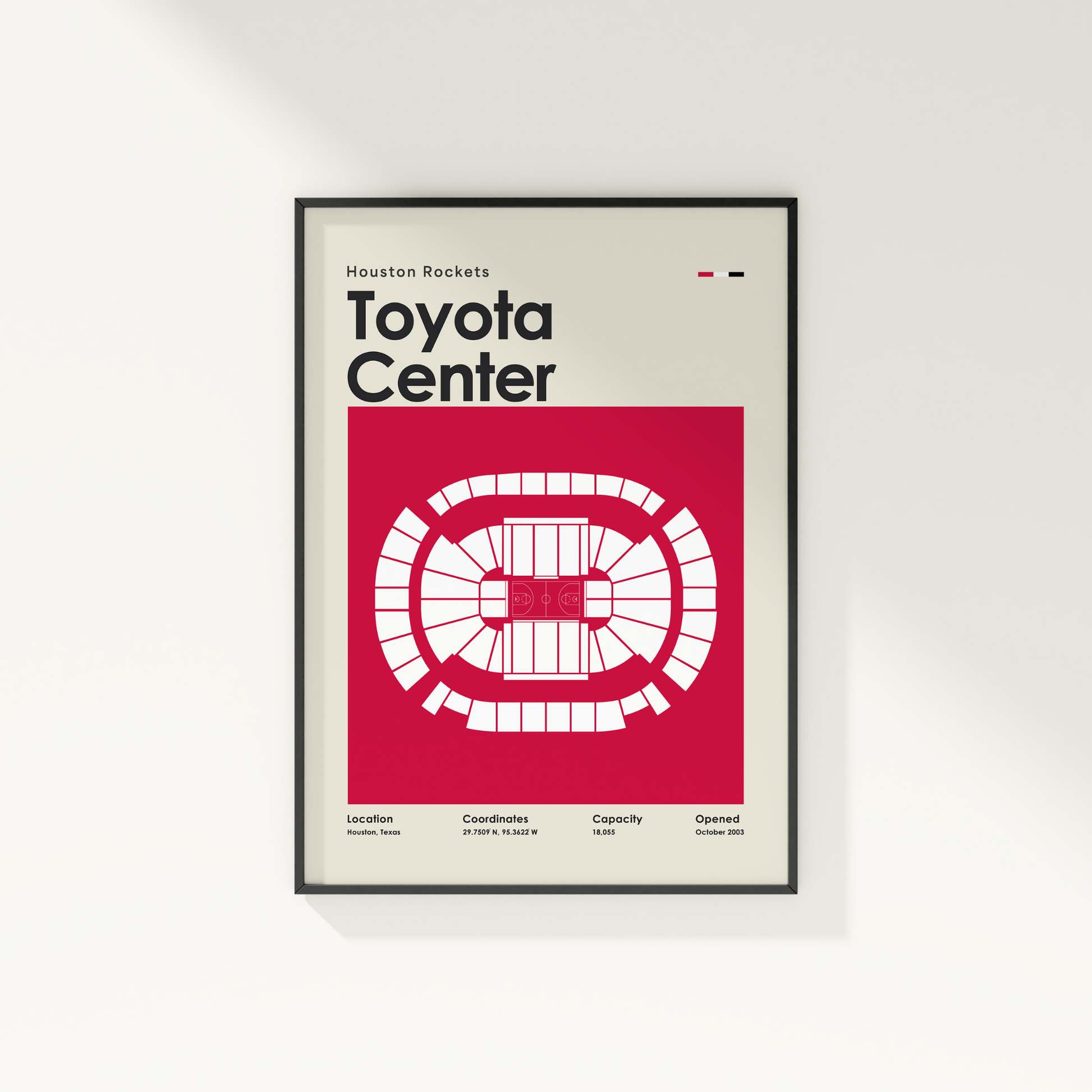 Framed poster of Toyota Center with Houston Rockets branding on a white wall.