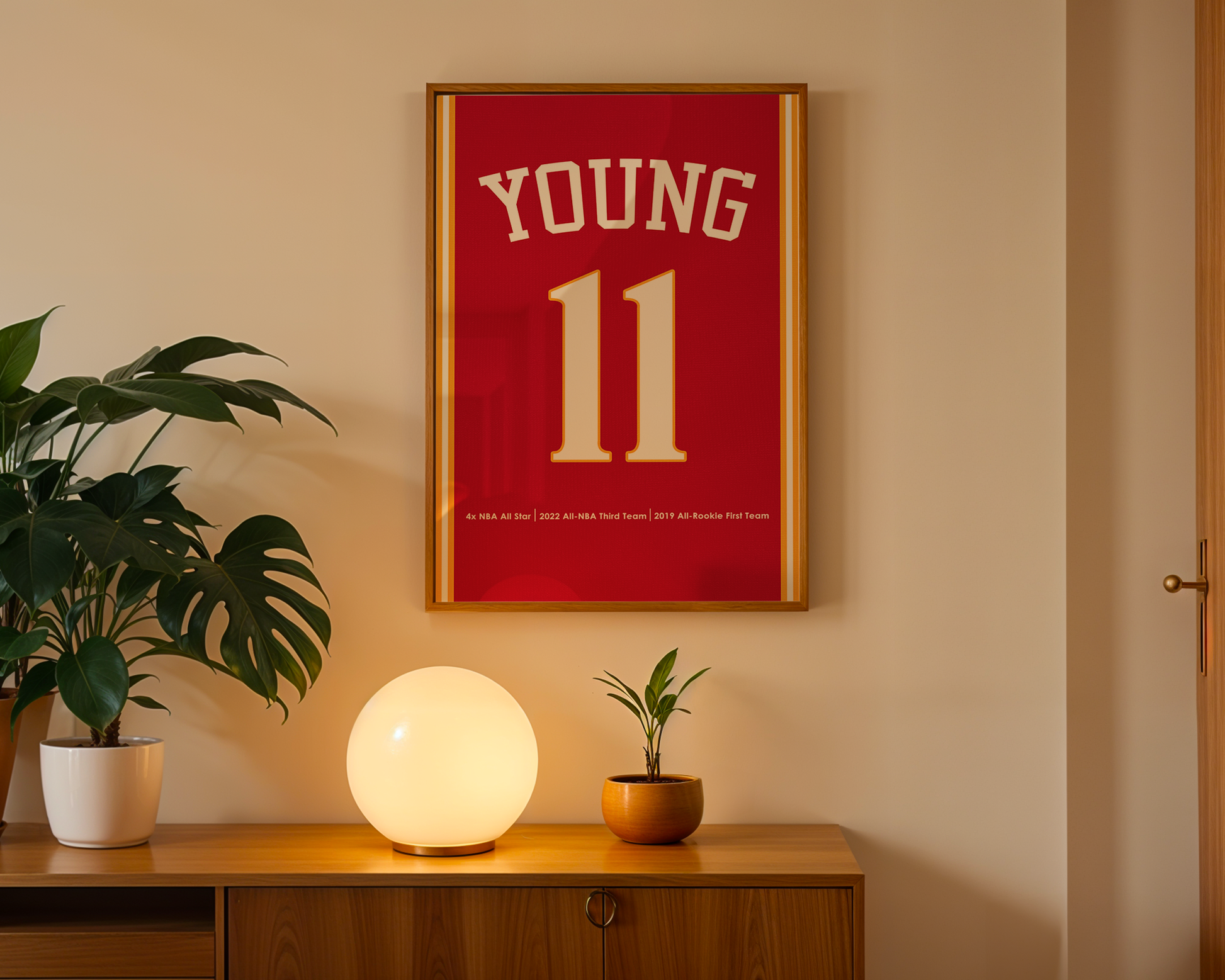 Framed red jersey with 'YOUNG 11' on a wall above a wooden cabinet with decorative items.