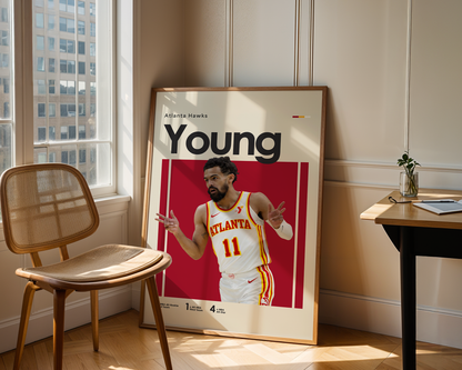 Framed sports poster of a basketball player in a room with a chair and table.