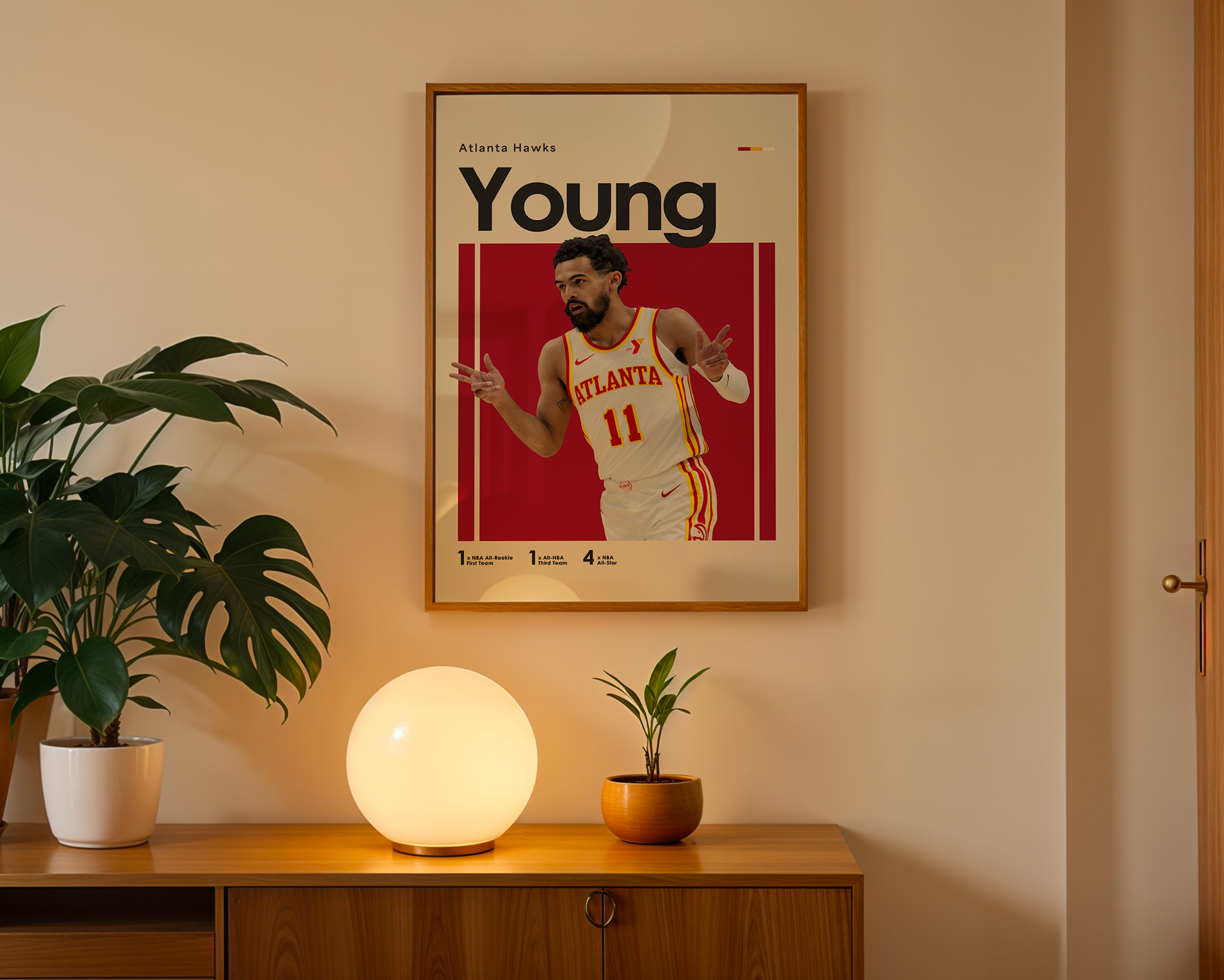 Framed poster of a basketball player on a wall above a wooden cabinet with decorative items.