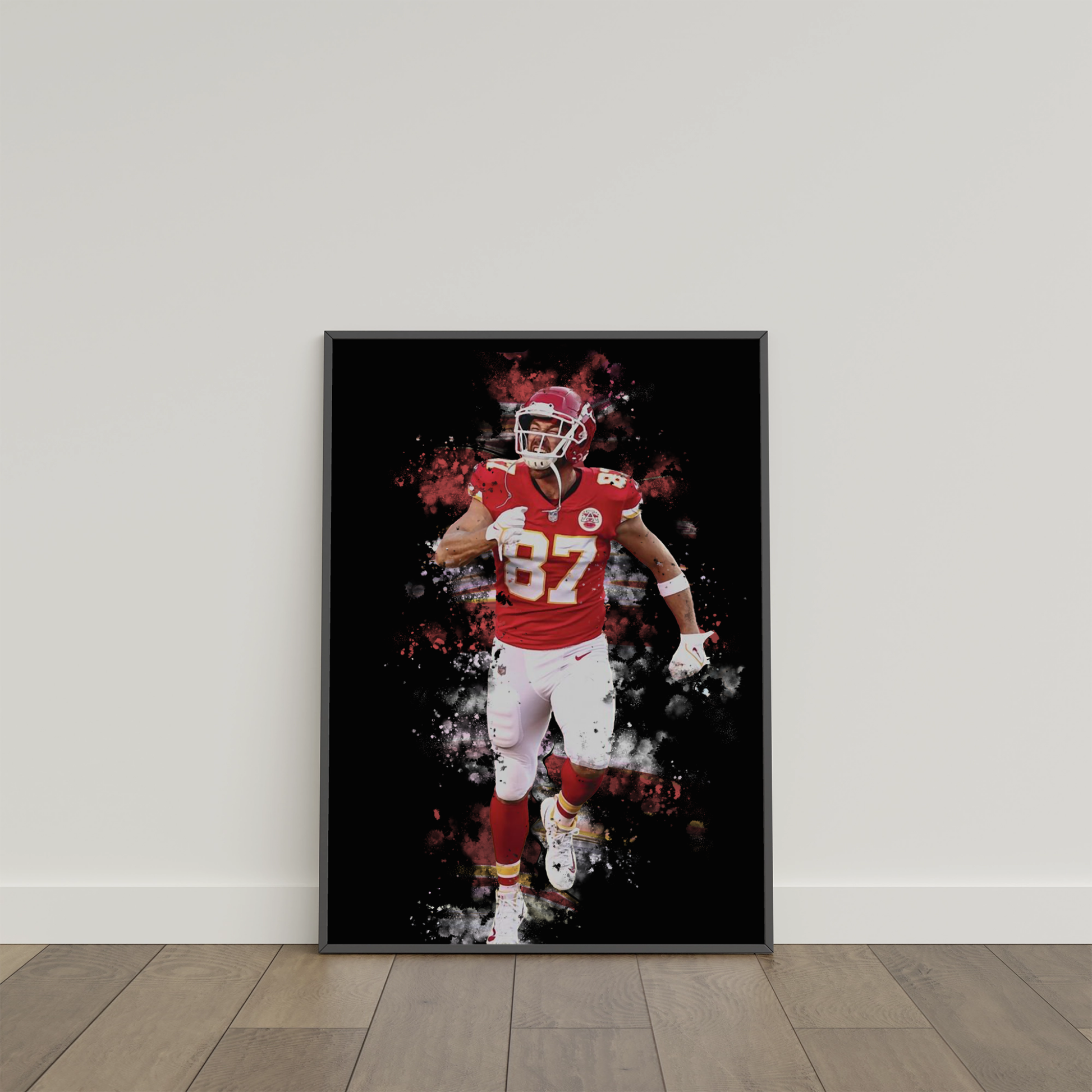 framed poster mockup of football player travis kelce leaning on a white wall