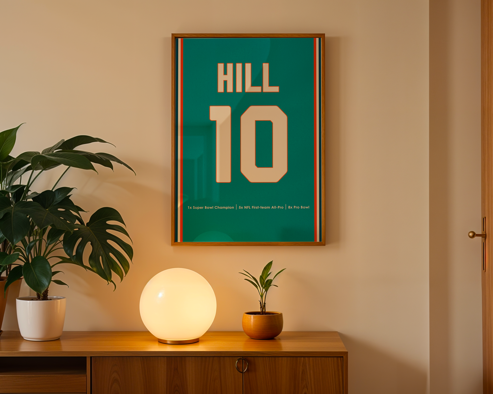 Framed poster with 'HILL 10' on a wall above a wooden cabinet with decorative items.