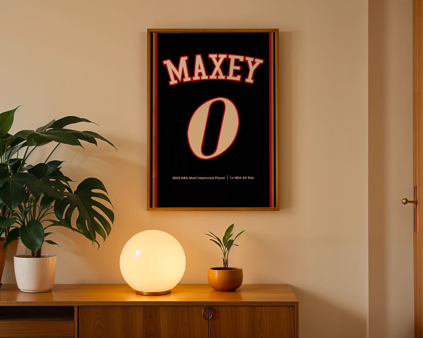 Framed poster with 'MAXEY' and '0' on a wall above a wooden cabinet with decorative items.