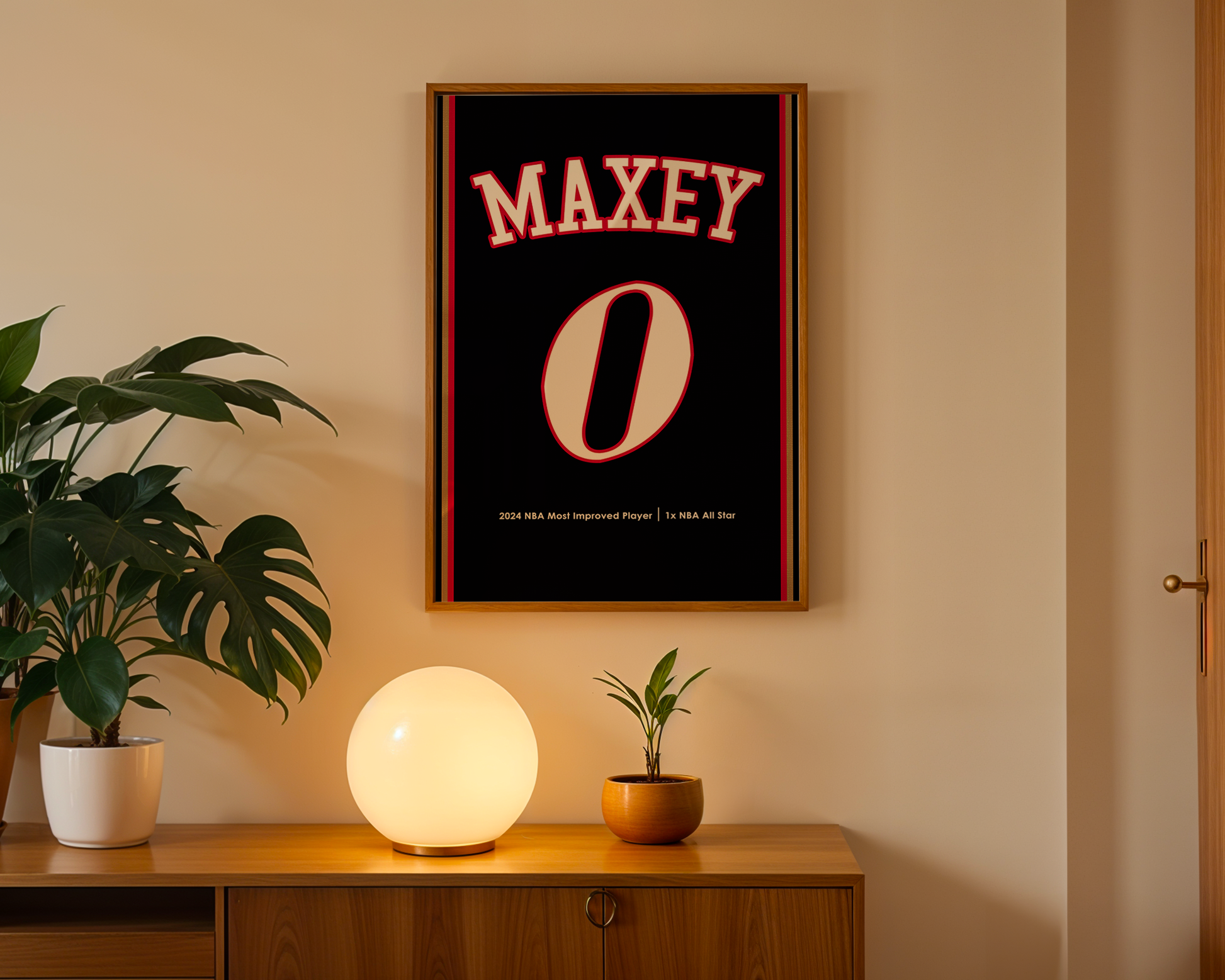 Framed poster with 'MAXEY' and '0' on a wall above a wooden cabinet with decorative items.