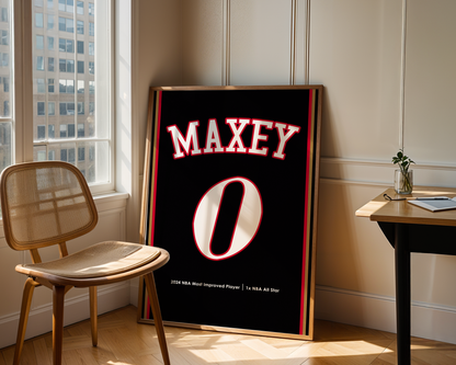 Framed sports jersey with 'MAXEY' and number '0' in a room with a window and chair.