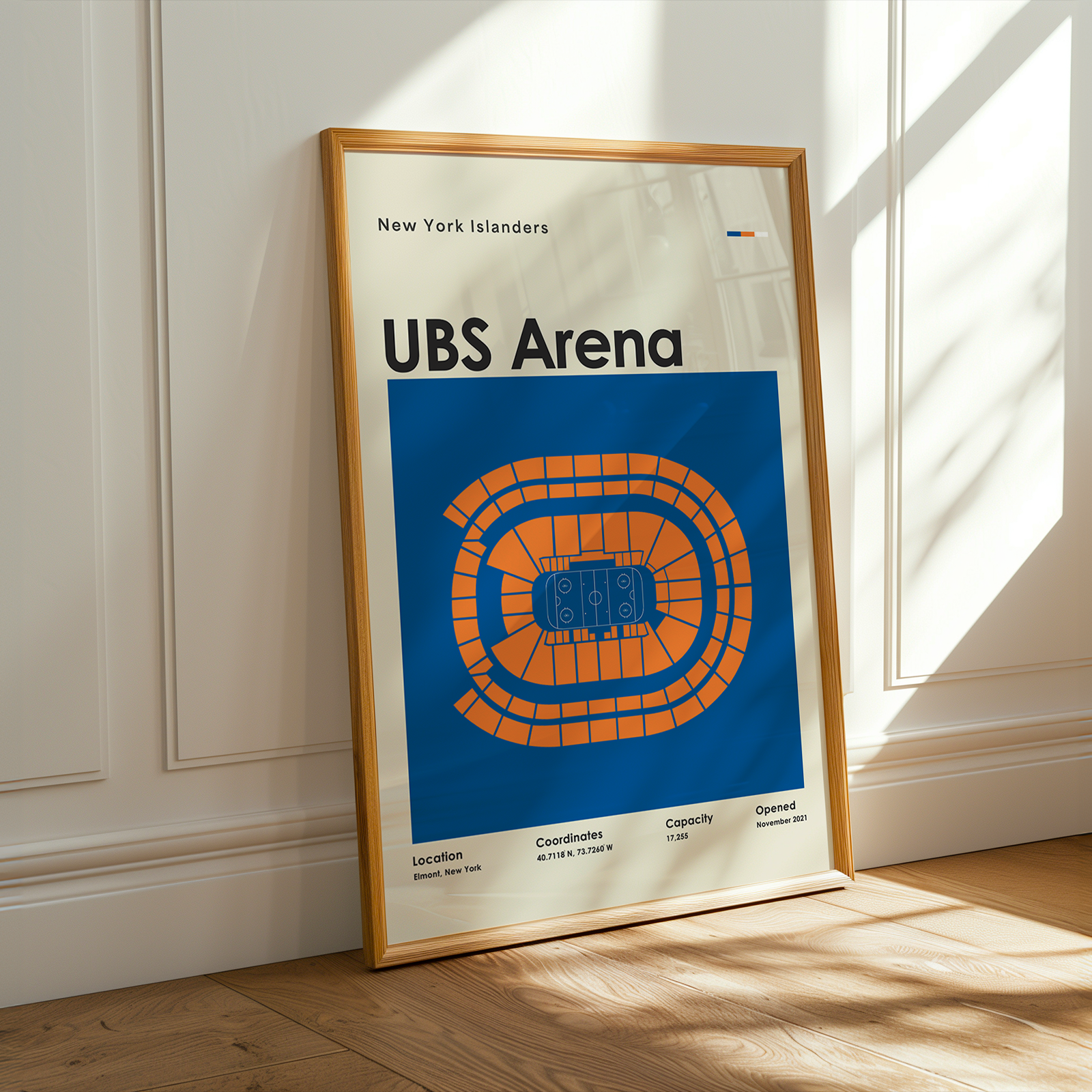 Framed poster of UBS Arena with New York Islanders branding on a wooden floor.