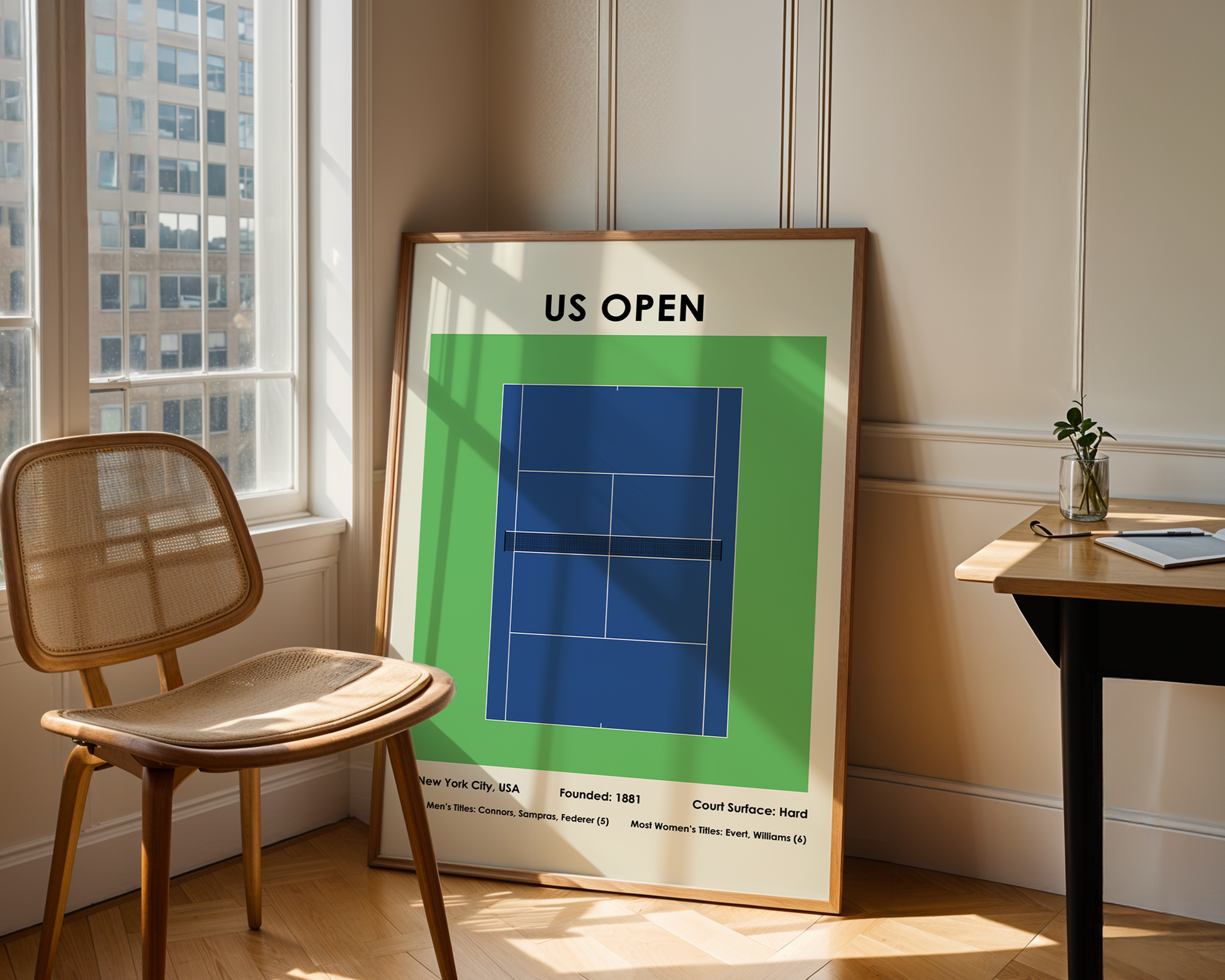 Framed poster of a tennis court layout with 'US Open' text in a room with a chair and table.