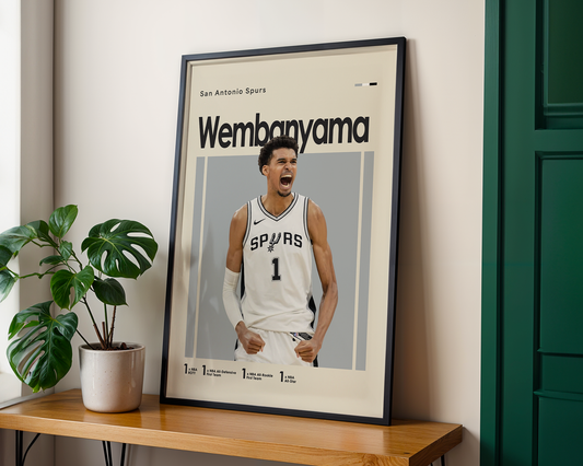 Framed poster of a basketball player in a white jersey with 'San Antonio Spurs' on a wooden shelf.