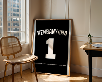 Framed jersey with 'Wembanyama 1' in a room with a chair and table.