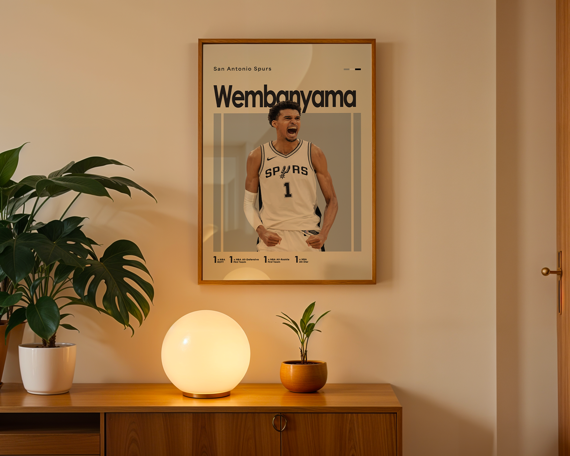 Framed poster of a basketball player on a wall above a wooden cabinet with decorative items.