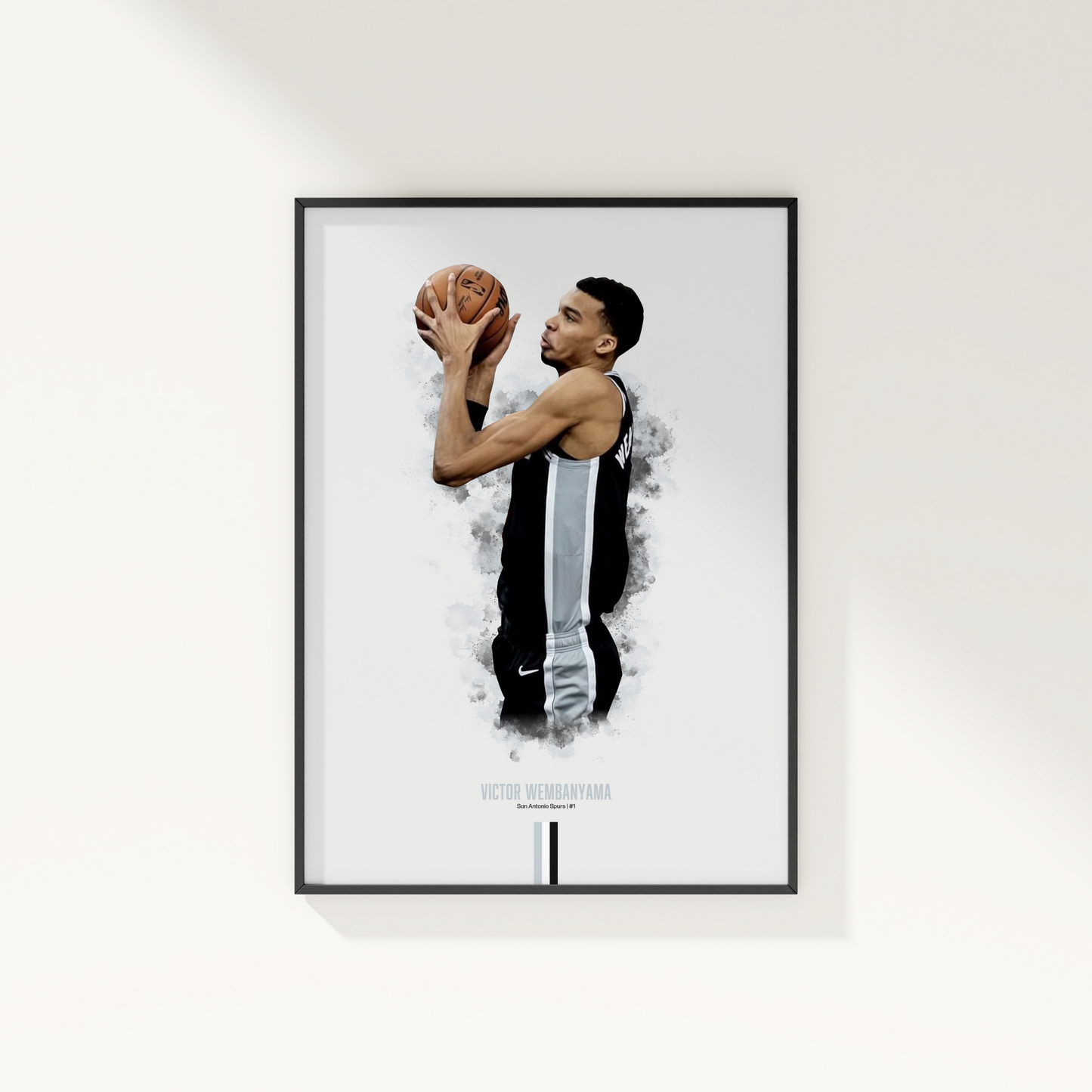 framed poster mockup of basketball player victor wembanyama hanging on a white wall