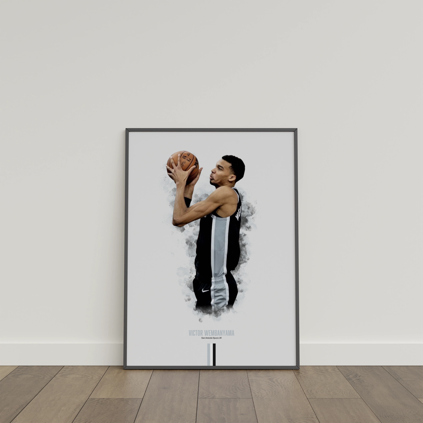 framed poster mockup of basketball player victor wembanyama leaning on a white wall