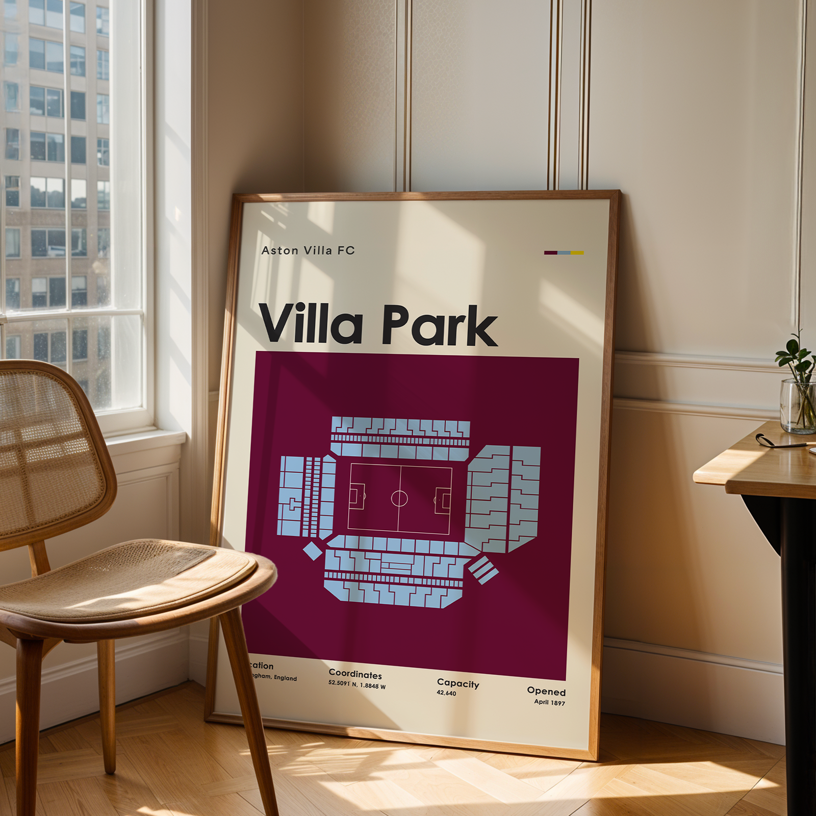 Framed map of Villa Park stadium in a room with a chair and table.