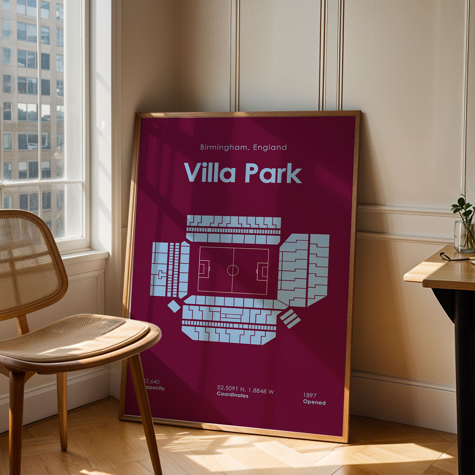 Framed map of Villa Park in Birmingham, England on a wall in a room with a chair and window.