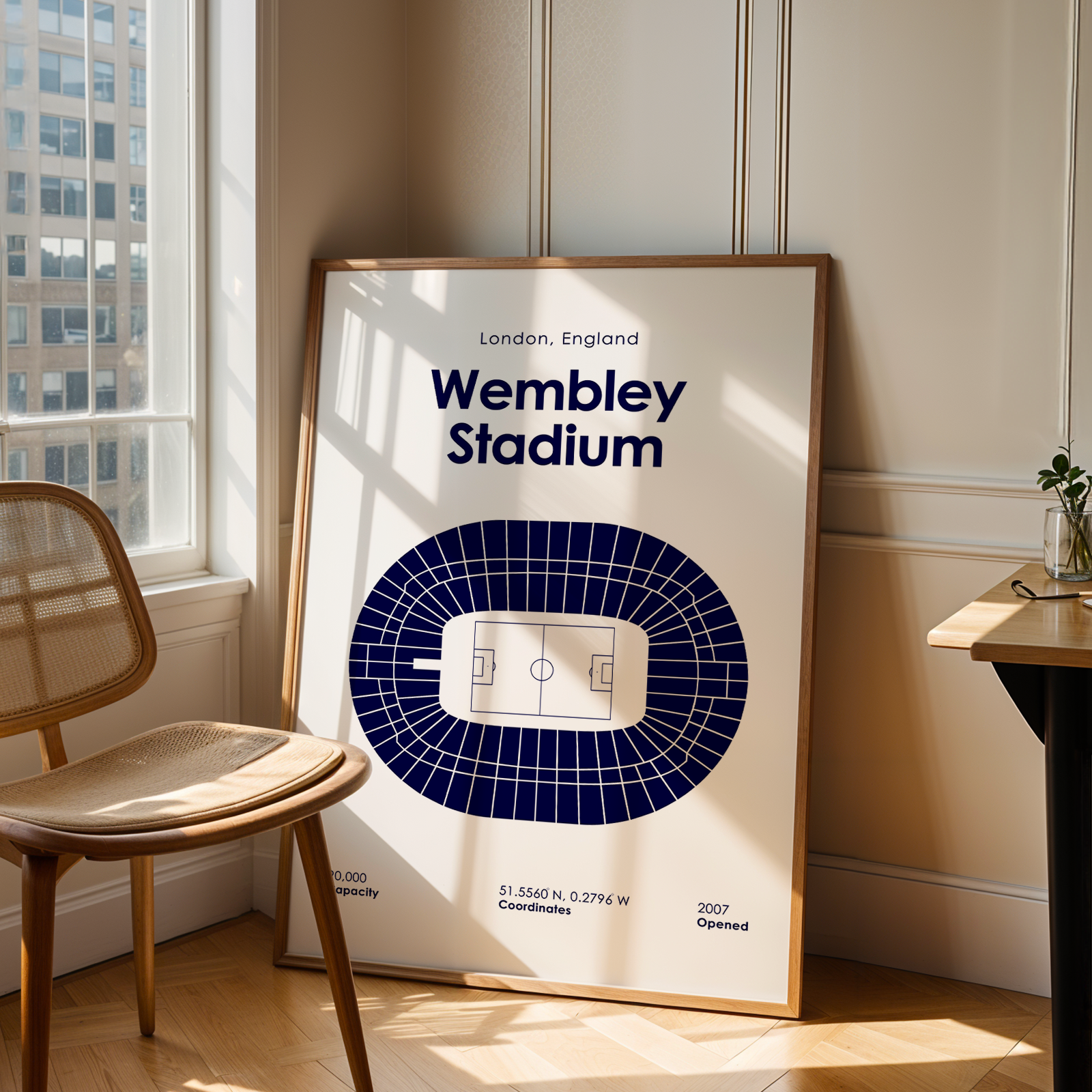 Framed map of Wembley Stadium in London, England, leaning against a wall with natural light.