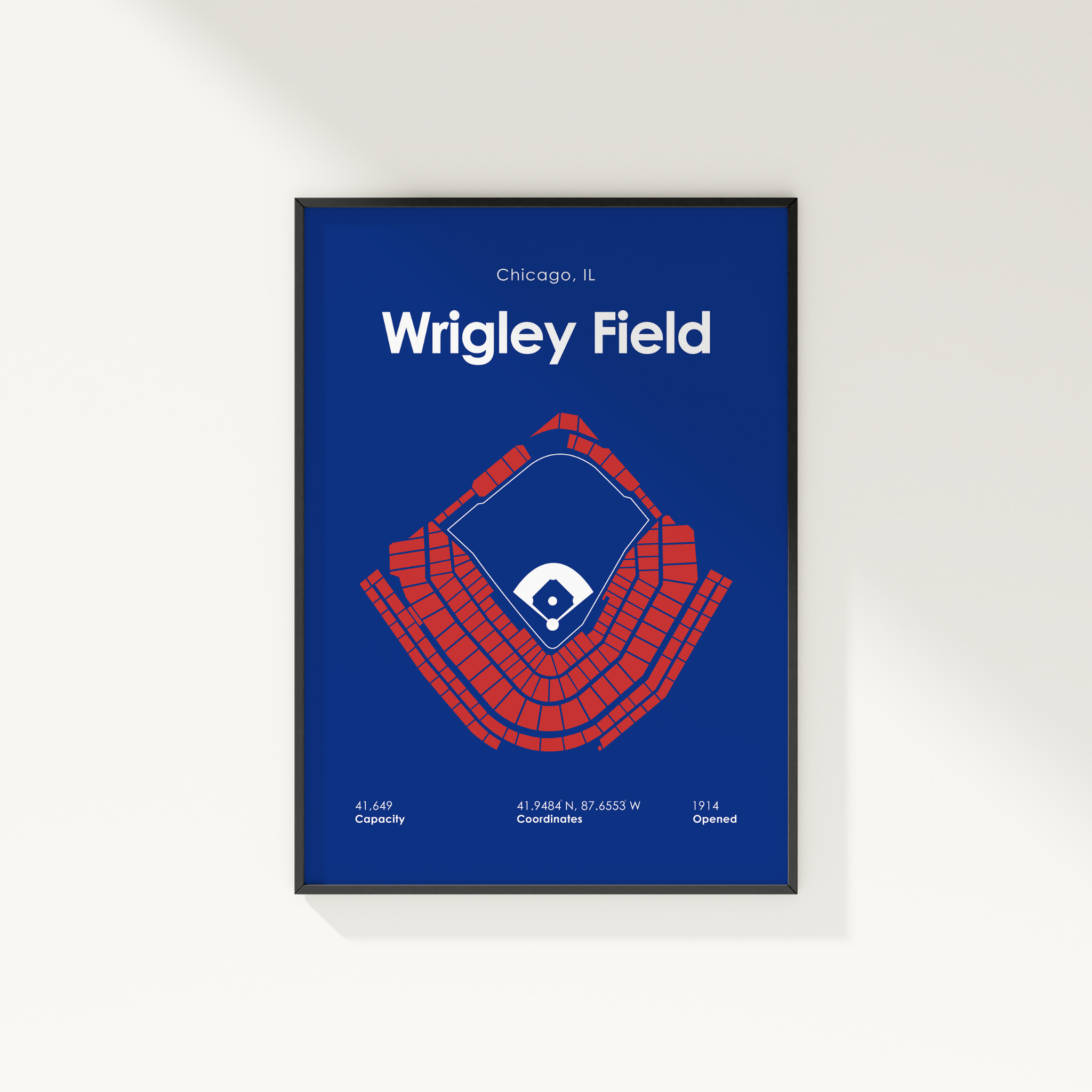 Framed poster of Wrigley Field with seating chart and coordinates on a blue background