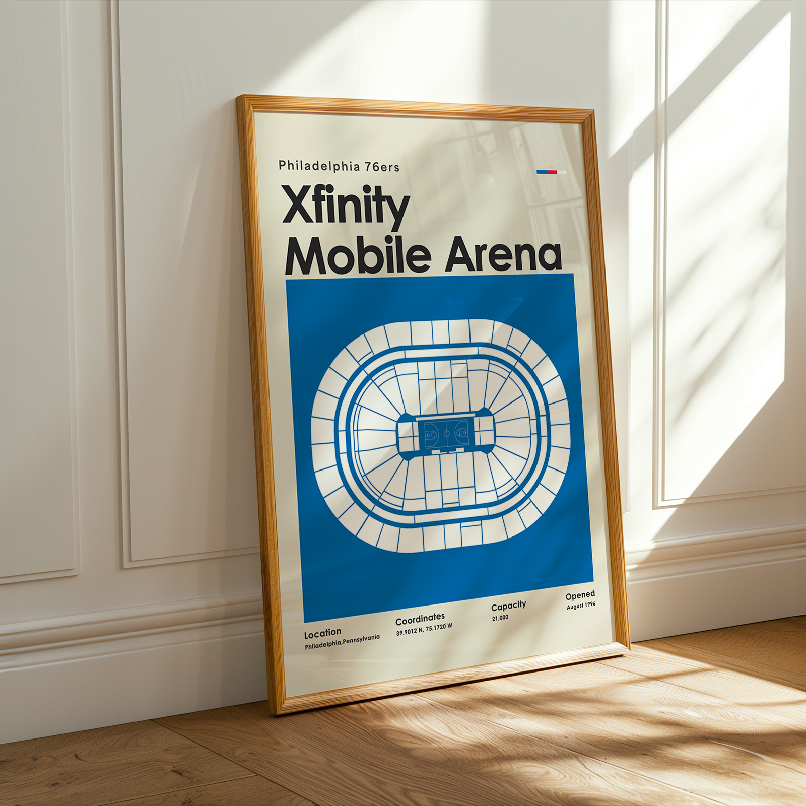 Framed poster of Xfinity Mobile Arena with Philadelphia 76ers branding on a wall.