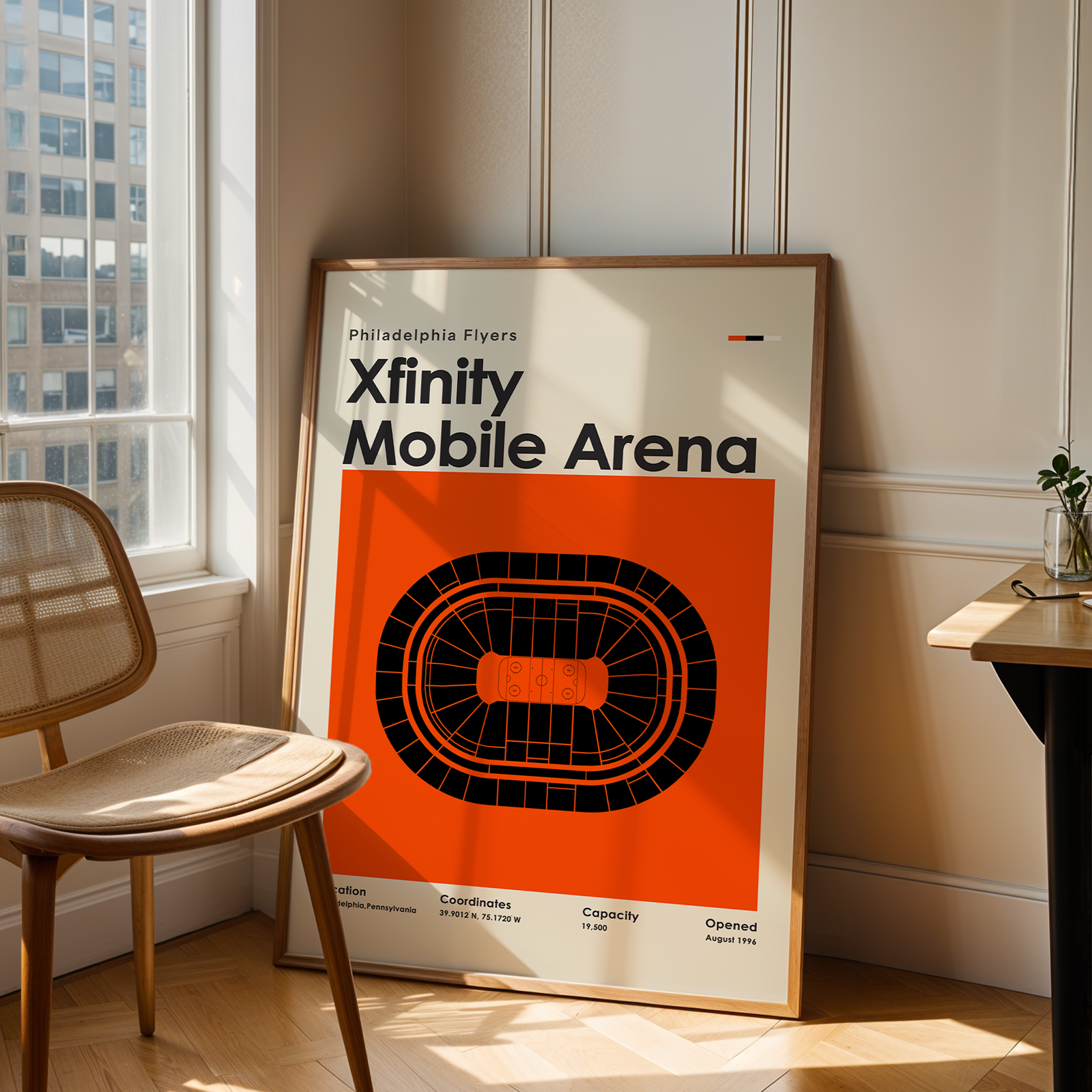 Poster of Xfinity Mobile Arena in a room with a chair and table.