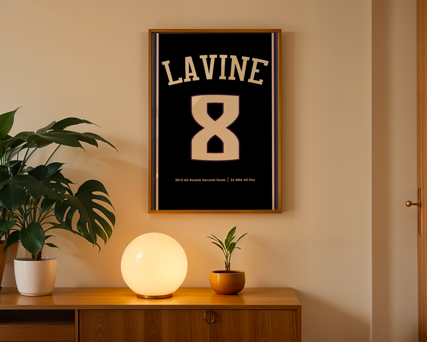 Framed artwork with 'LAVINE' and number '8' on a wall above a wooden cabinet with decorative items.